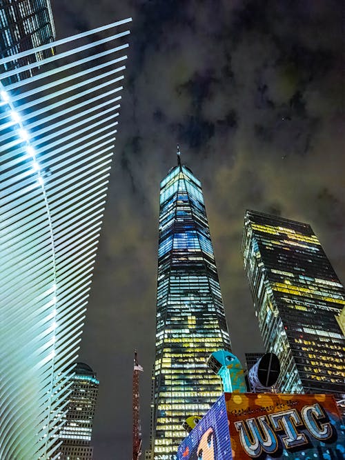 Low Angle Shot of Colorful High Rise Buildings Under Dark Sky