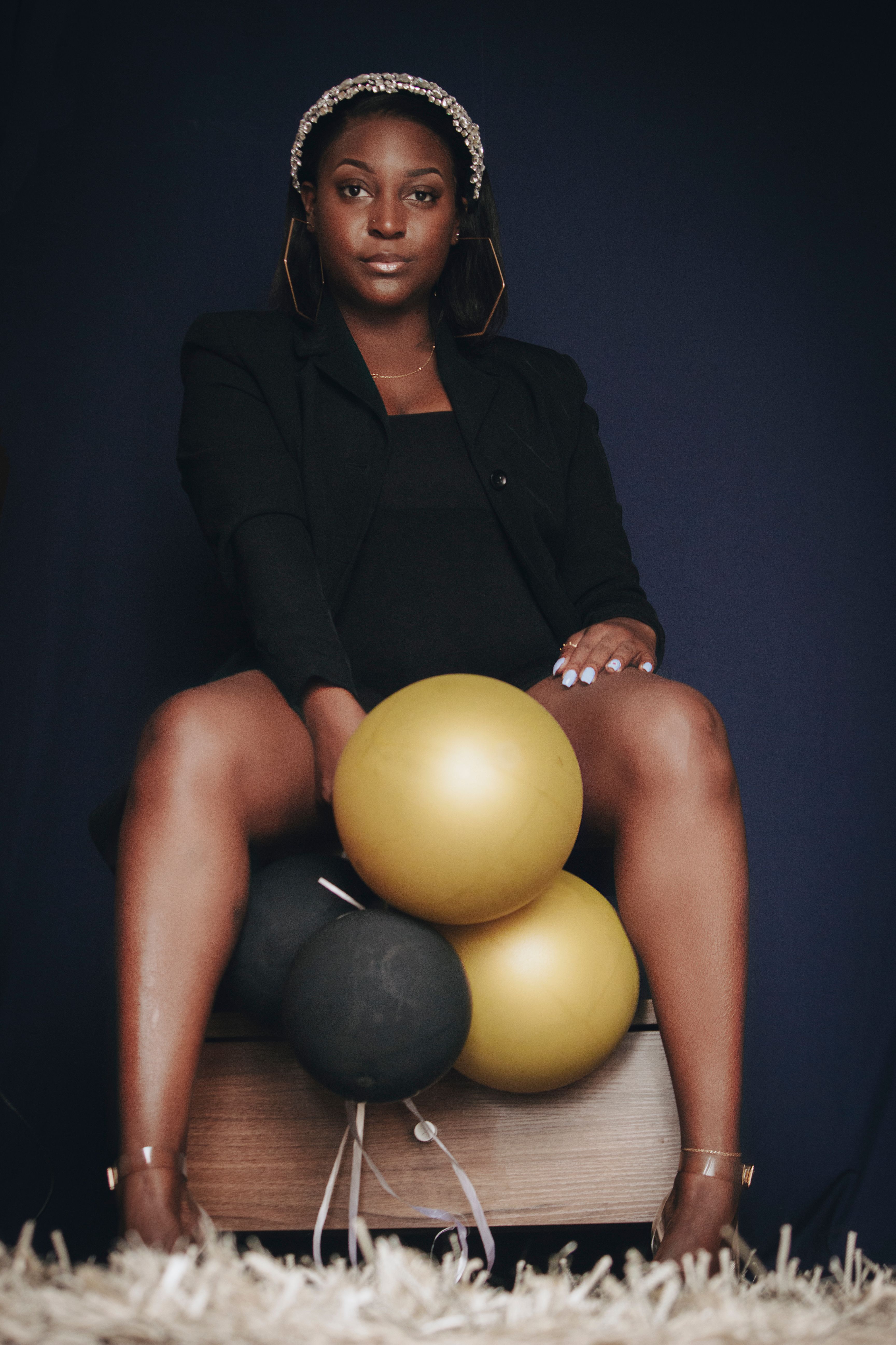 Woman in Black Blazer Sitting on a Chair while Holding Balloons · Free ...