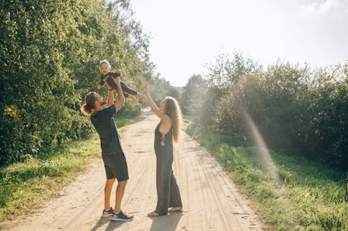 Couple with Their Little Boy Standing on Dirt Road