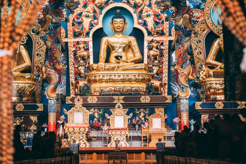 Free Stunning view of the golden Buddha statue in an intricately decorated temple interior. Stock Photo