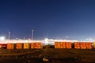 Red Cargo Containers on Field Under Blue Sky