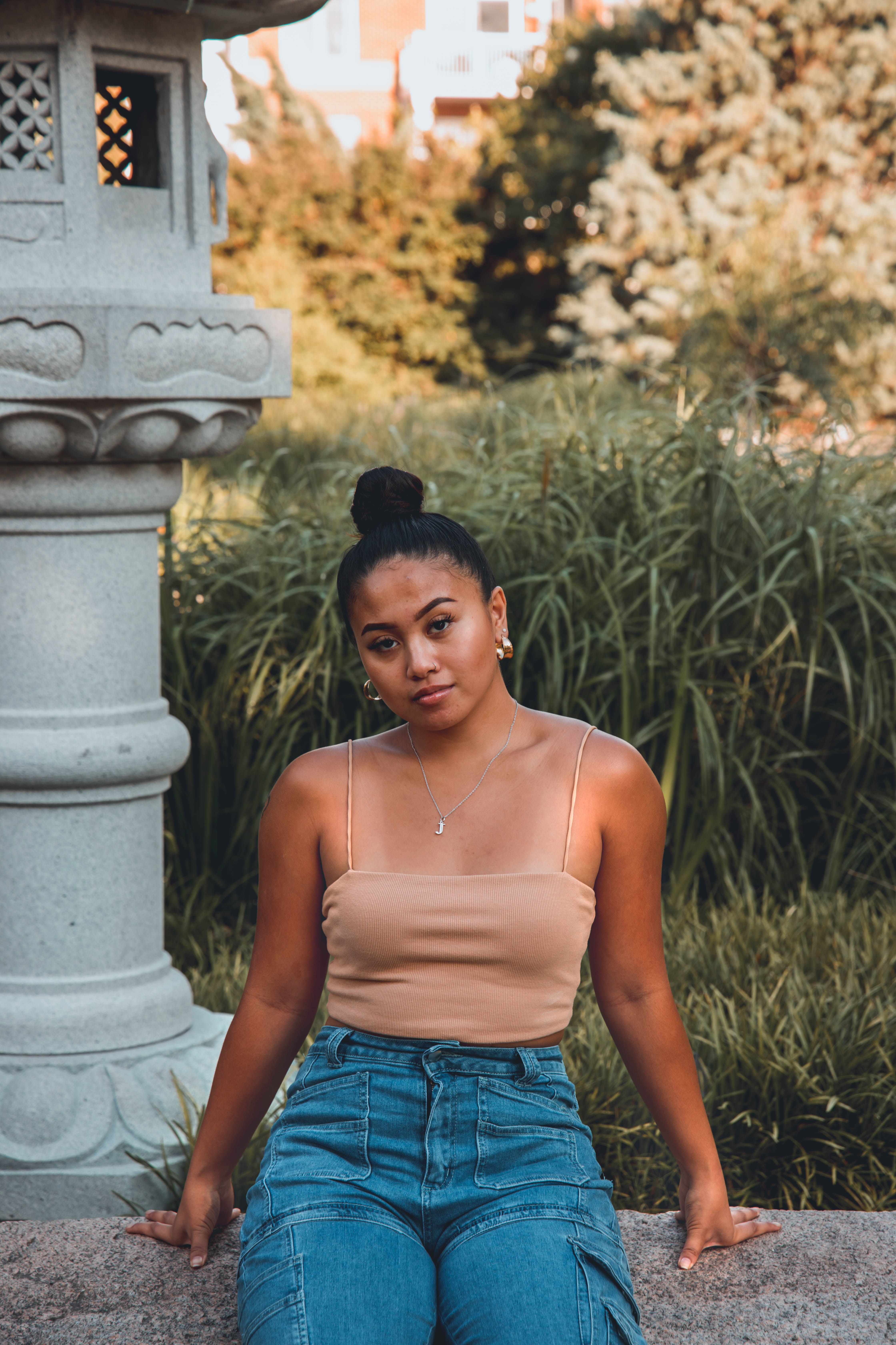 Woman in White Camisole and Blue Jeans 