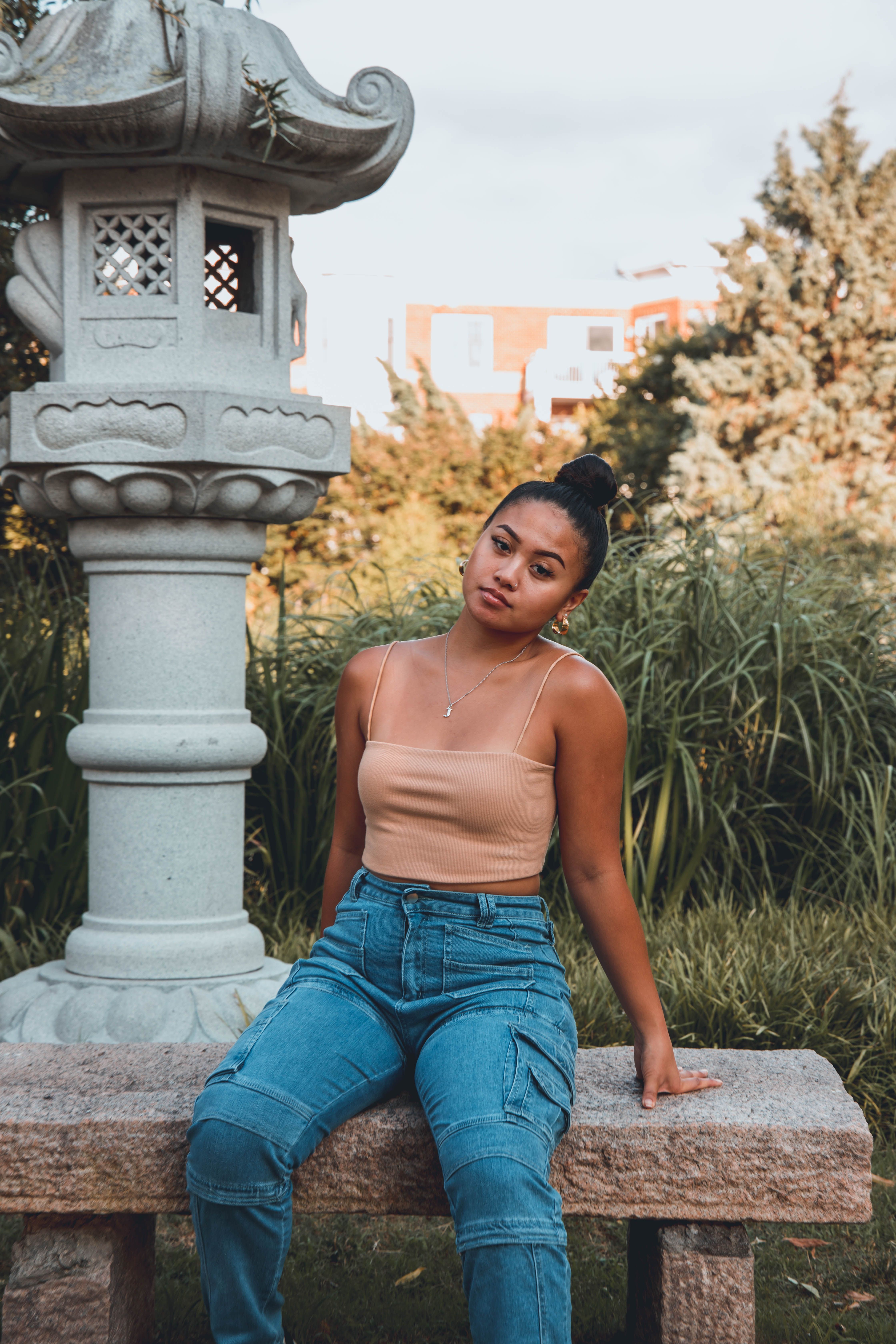 Woman Sitting on a Gray Concrete Bench · Free Stock Photo