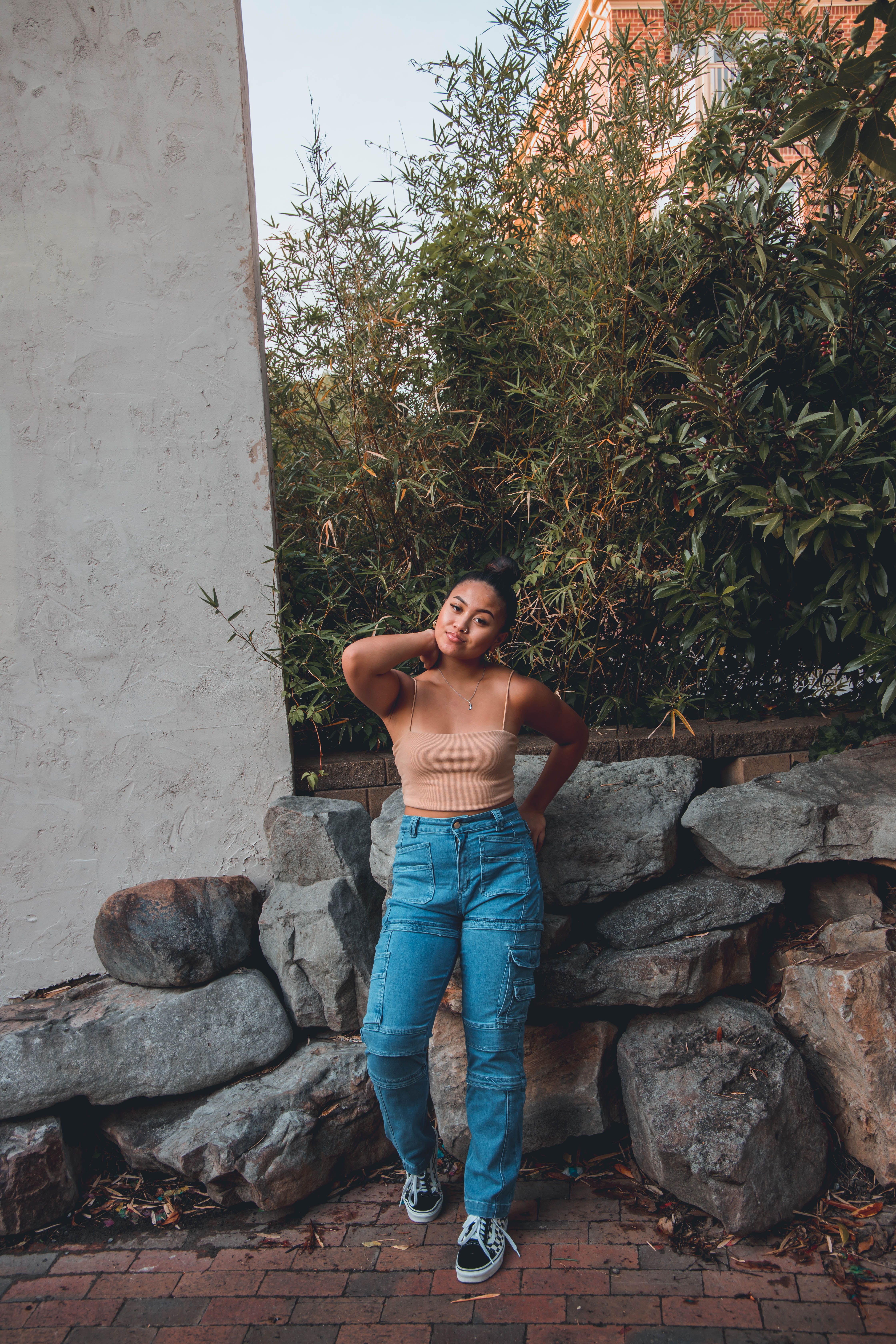 A Woman Wearing Brown Tank Top and Blue Denim Jeans · Free Stock Photo