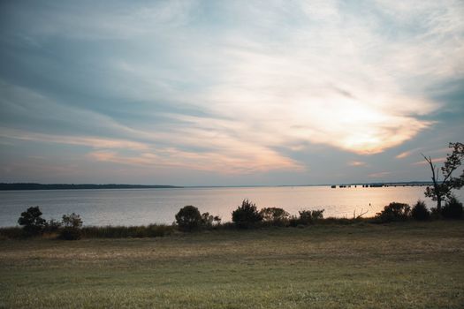 Calm and tranquil lakeside view with a scenic sunset, evoking peace and relaxation.