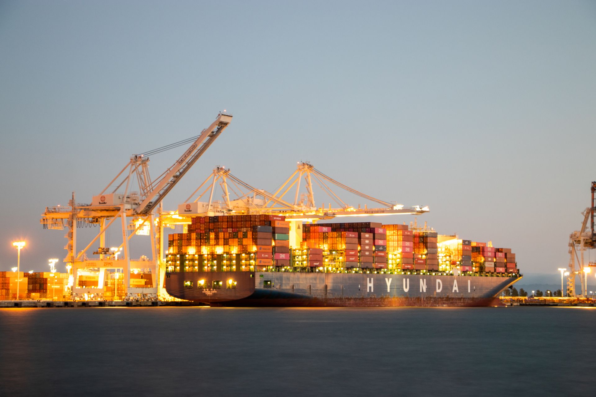 Container ship docked at a commercial port at dusk
