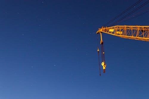 Free A Yellow Crane Under Blue Sky Stock Photo