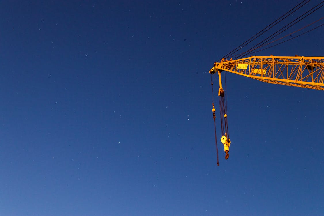 Free A Yellow Crane Under Blue Sky Stock Photo