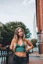 Blonde Girl Wearing Green Crop Top and Jeans Posing in City Street
