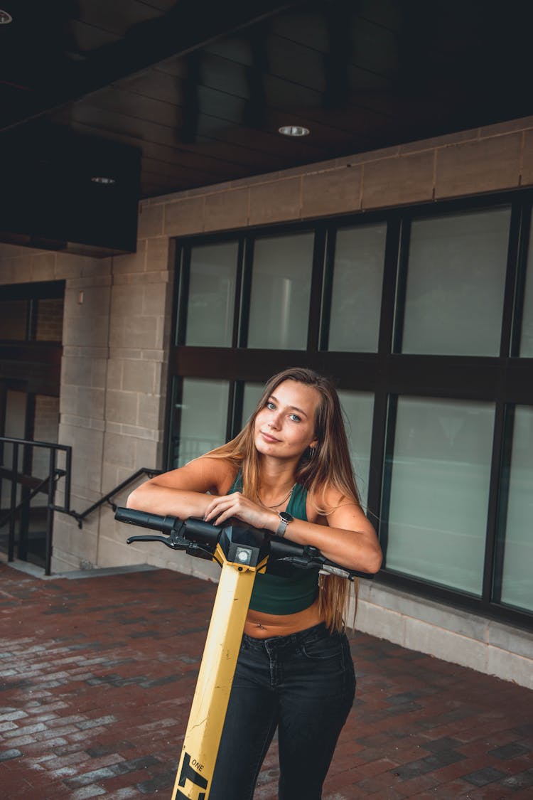 Young Woman Outdoors With Scooter