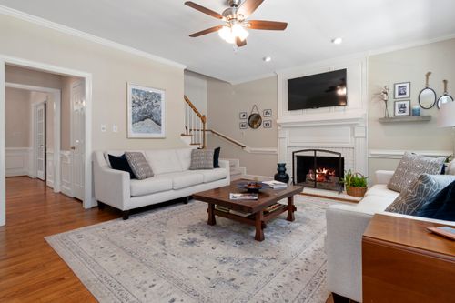 Free Warm, stylish living room with sofas, fireplace, and wooden accents. Stock Photo