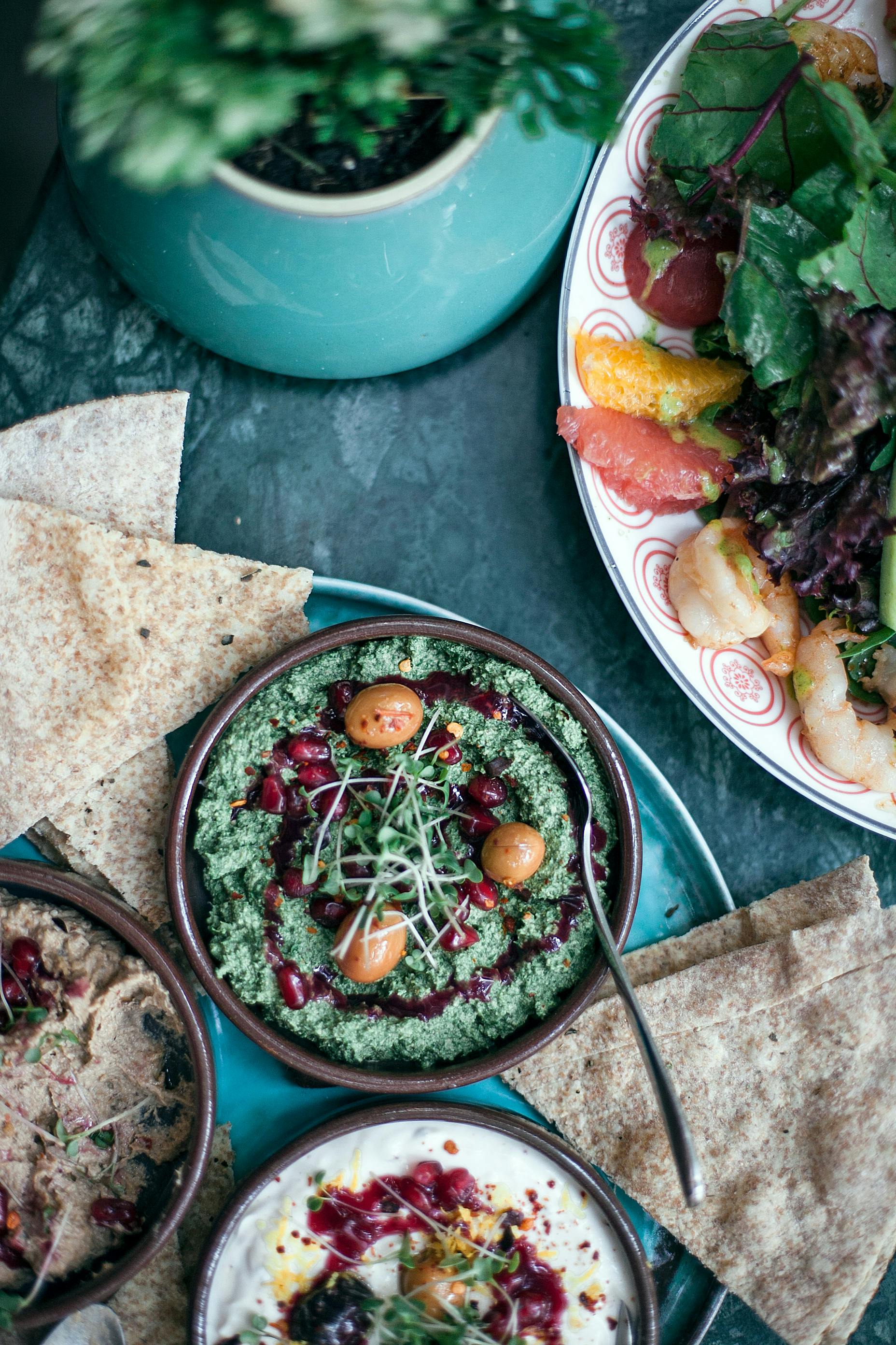 appetizing assorted hummus served with mixed salad in cafe