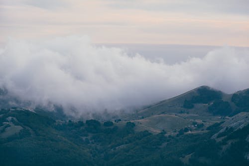 Mountain ridge against foggy sundown sky