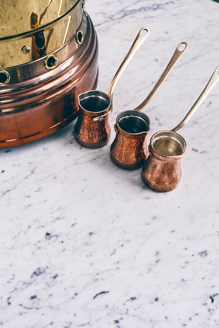 Traditional Oriental Coffee Pots And Copper Brazier Placed On Marble Table