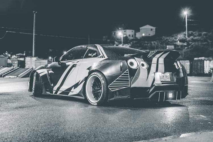 Modern Racing Car On City Road At Night