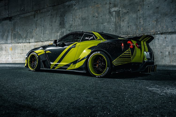 Modern Racing Car On City Road At Dusk