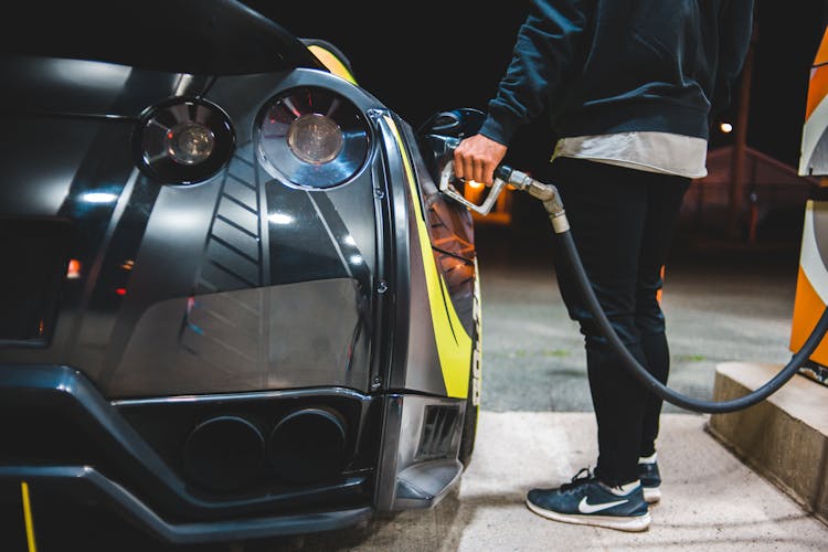 Crop Man Refueling Sports Car In Gas Station