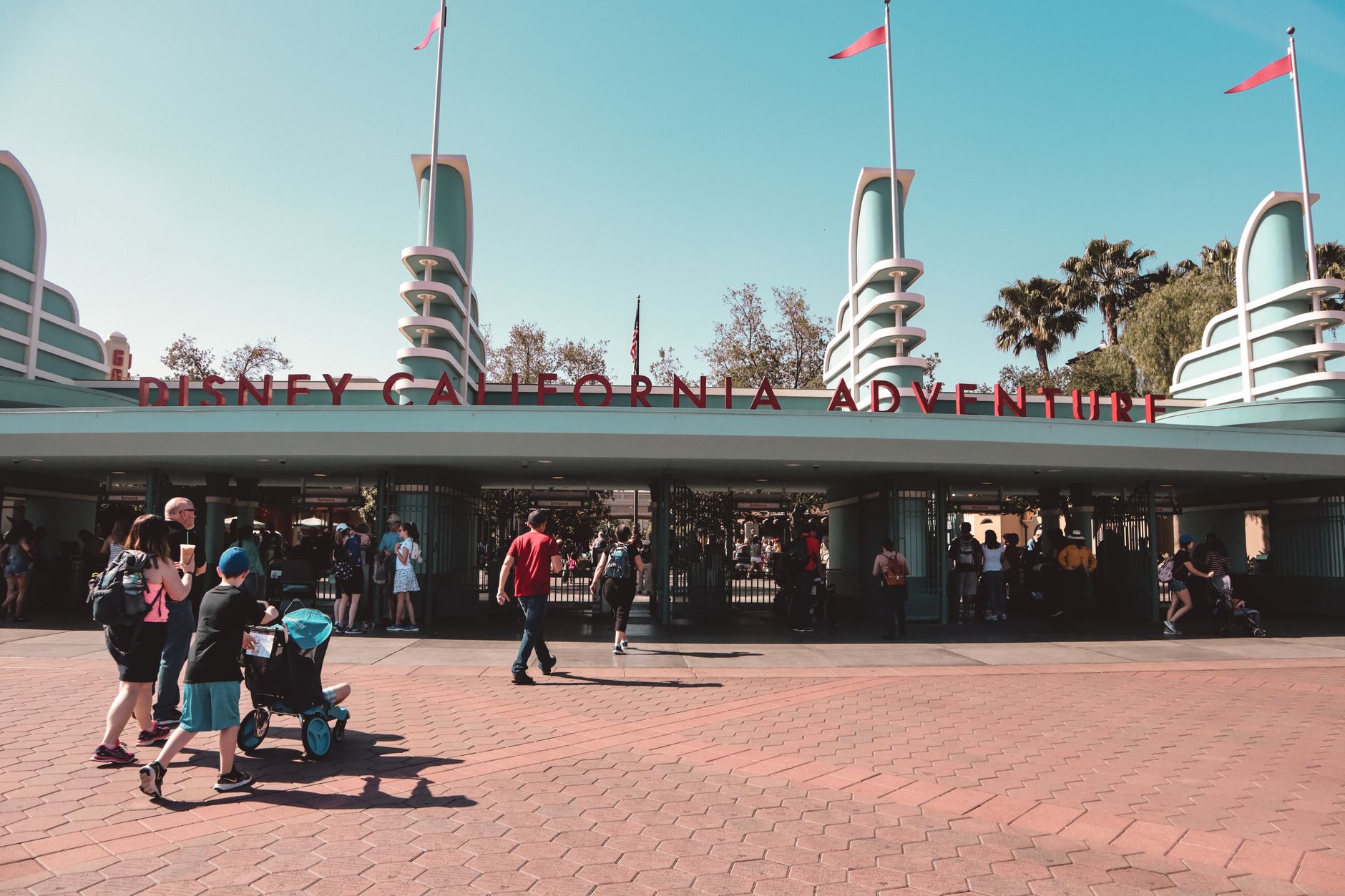 Visitors at Disney California Adventure Park entrance in Anaheim, a popular family destination.