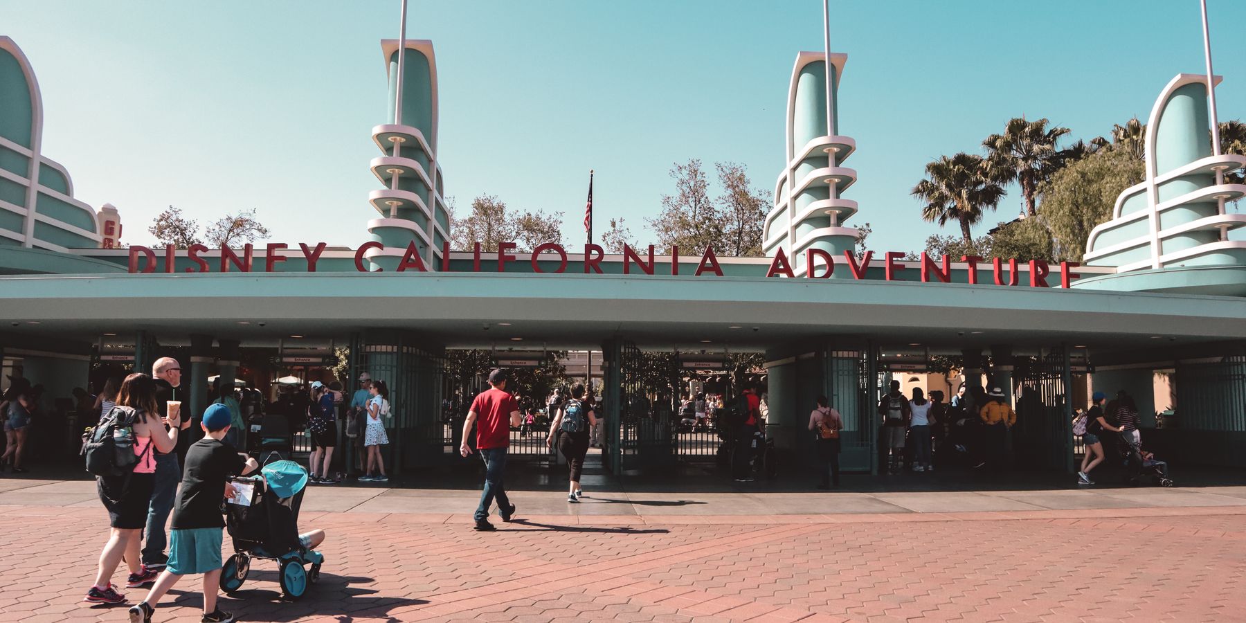 Visitors at Disney California Adventure Park entrance in Anaheim, a popular family destination.