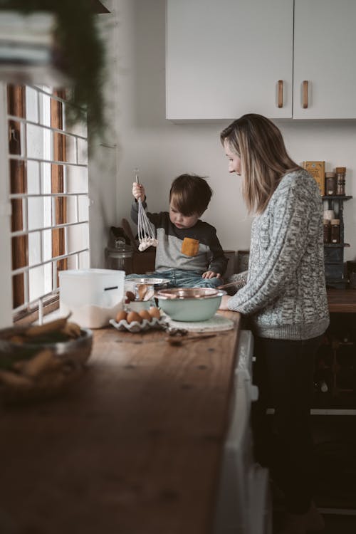 Free A Mother and Son Baking in the Kitchen Stock Photo