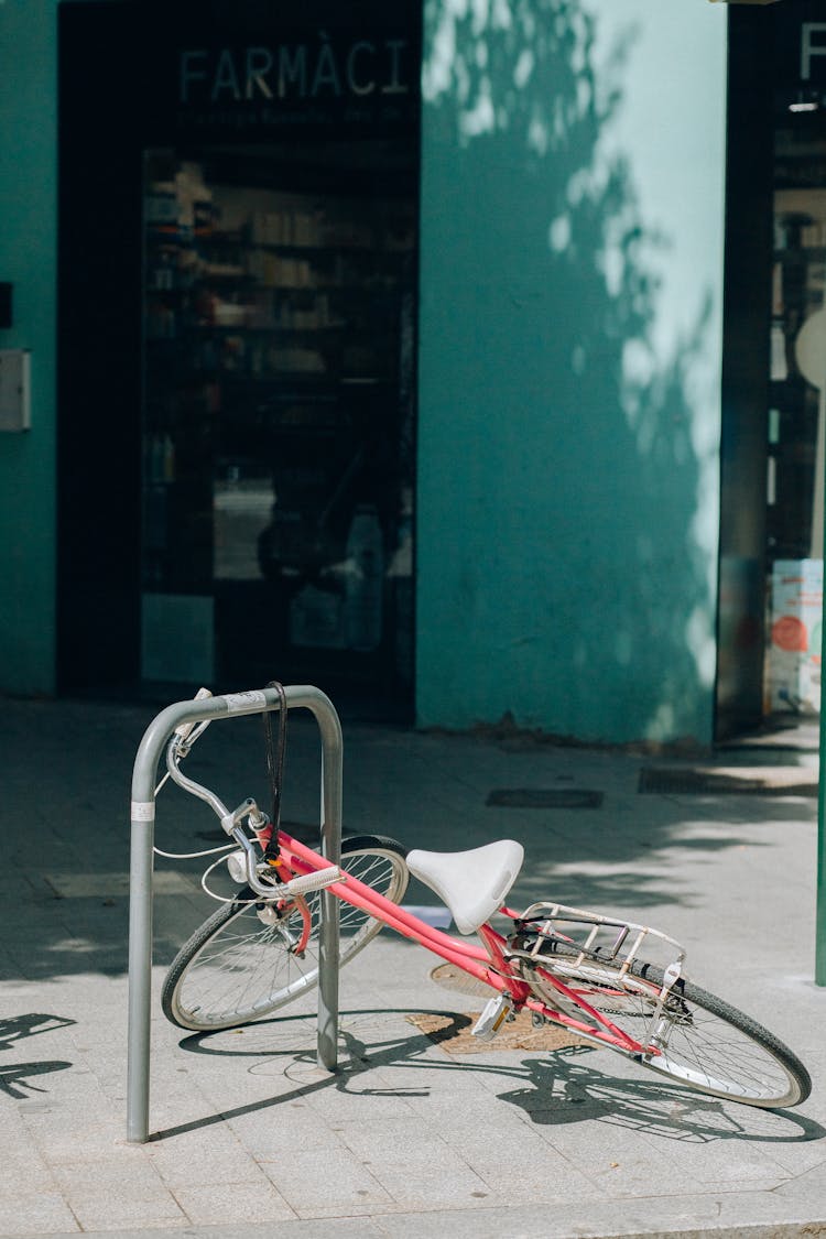 A Bicycle Locked On A Bike Rack