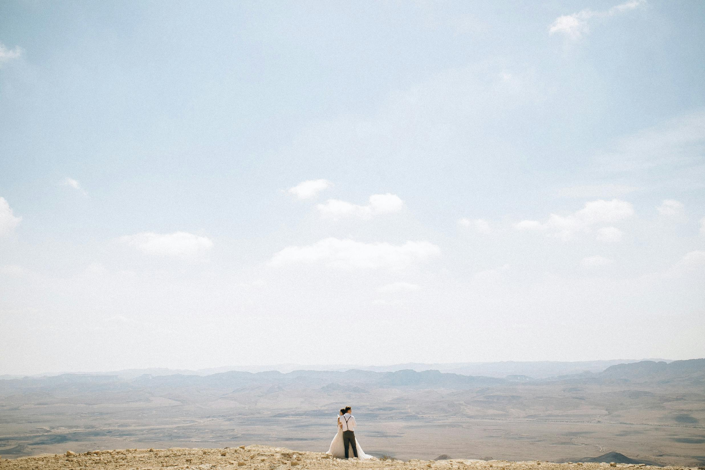 a couple standing in an arid land