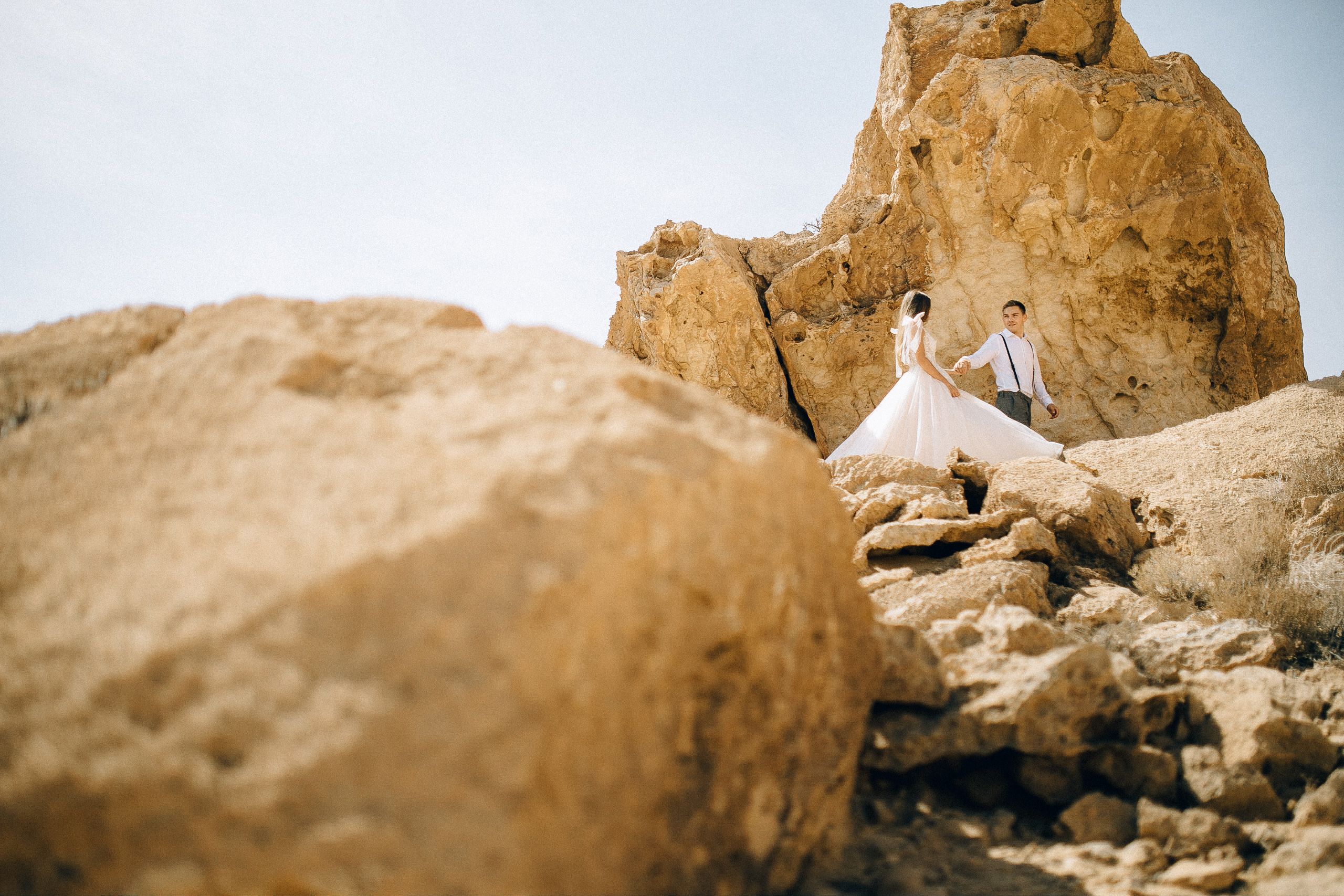 Low Angle Photography of Bride and Groom Standing Near Rock Formation ...