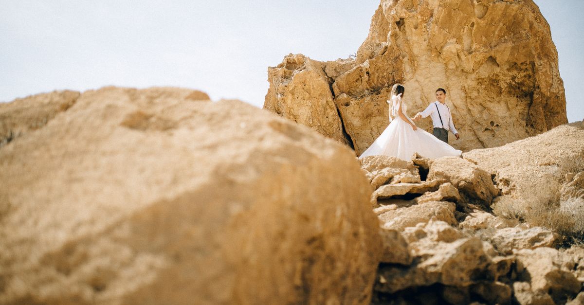Bride Formations Rocks Low Angle Photography of Bride and Groom Standing Near Rock Formation ...