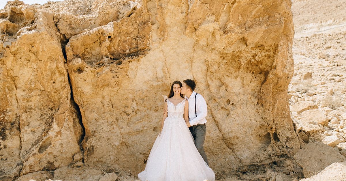 Bride Formations Rocks Bride and Groom Standing Beside a Rock Formation · Free Stock Photo