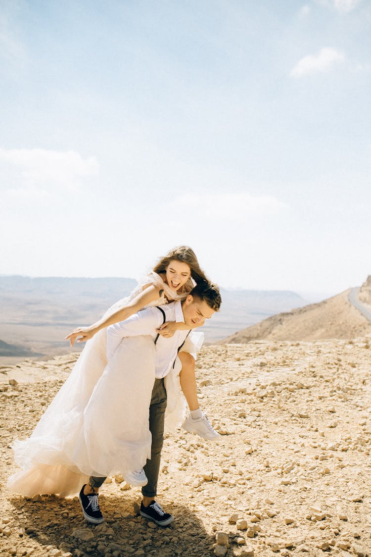 Groom Carrying His Bride On His Back