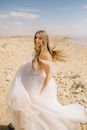 A Woman Wearing Her Wedding Gown in the Desert