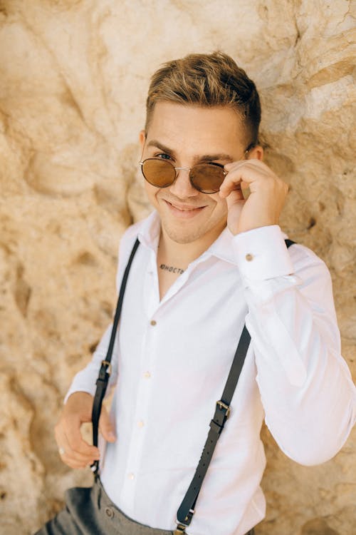Man in Button Down Shirt Holding His Sunglasses
