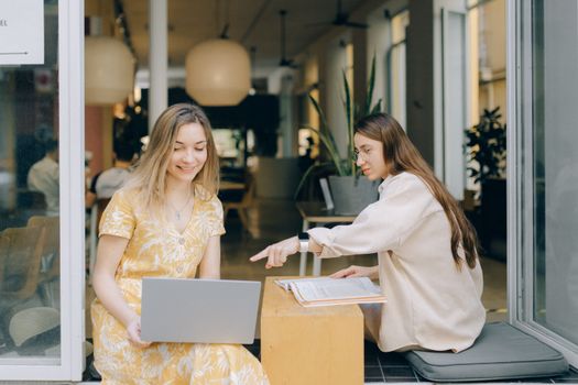 Woman in White Long Sleeve Shirt Using Silver Macbook