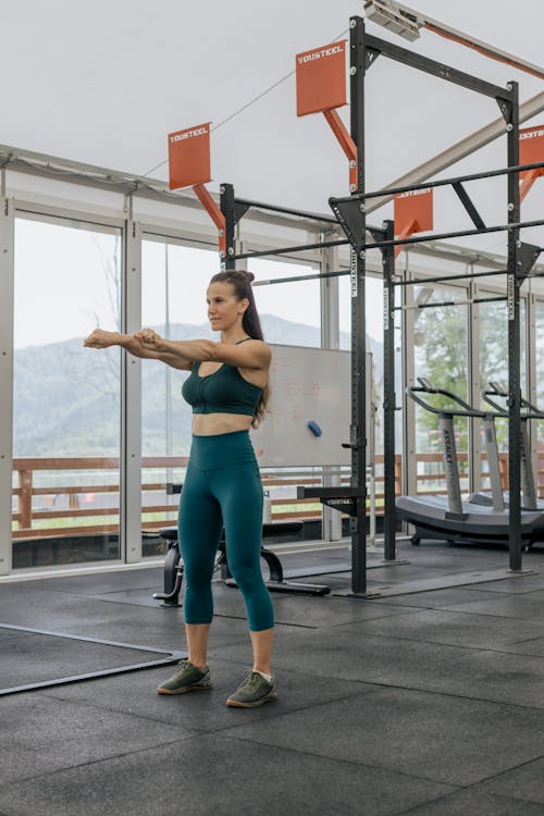 Woman Doing Stretching at the Gym