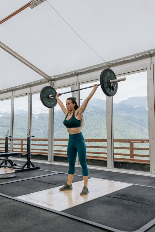 Strong Woman Lifting a Barbell