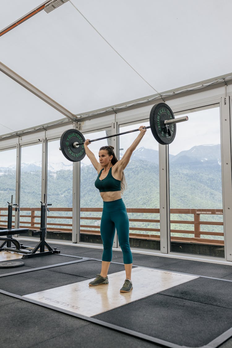 Strong Woman Lifting A Barbell