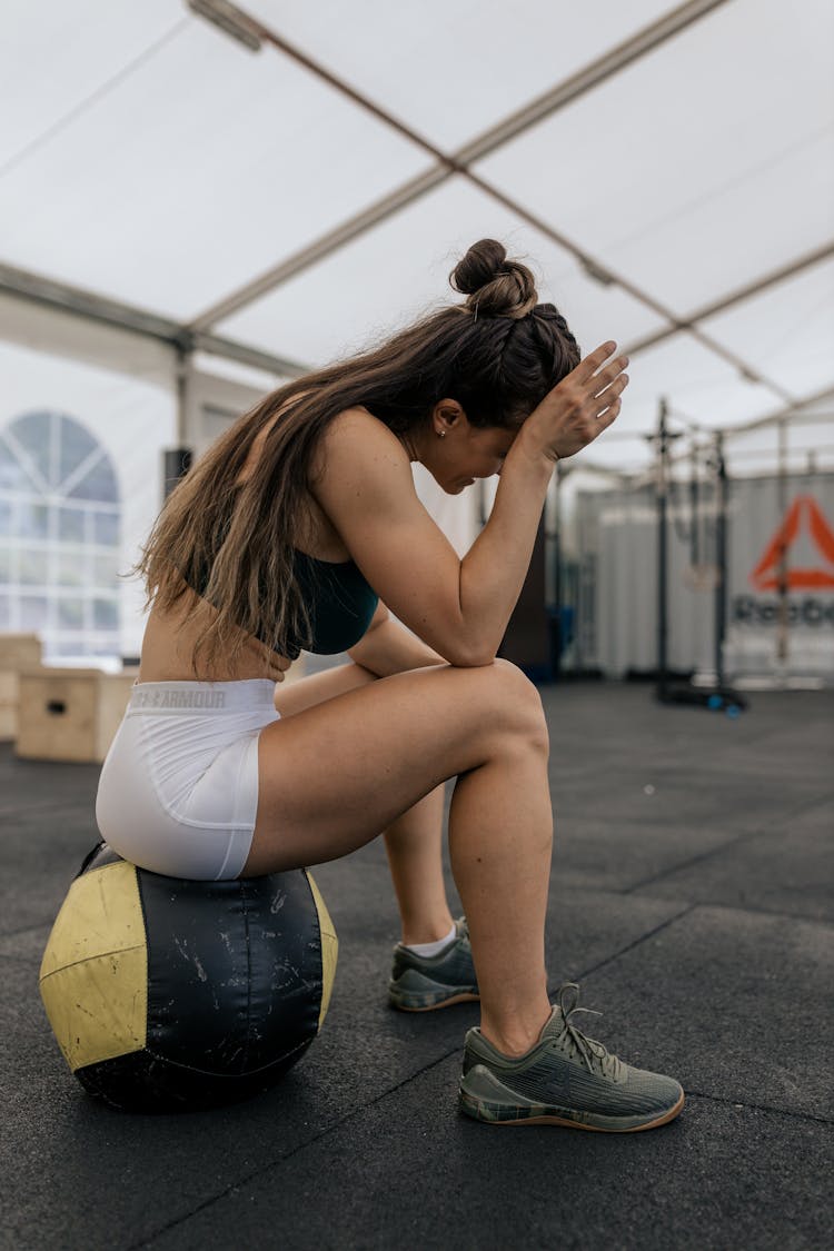 Woman In Sports Bra Sitting On An Exercise Ball