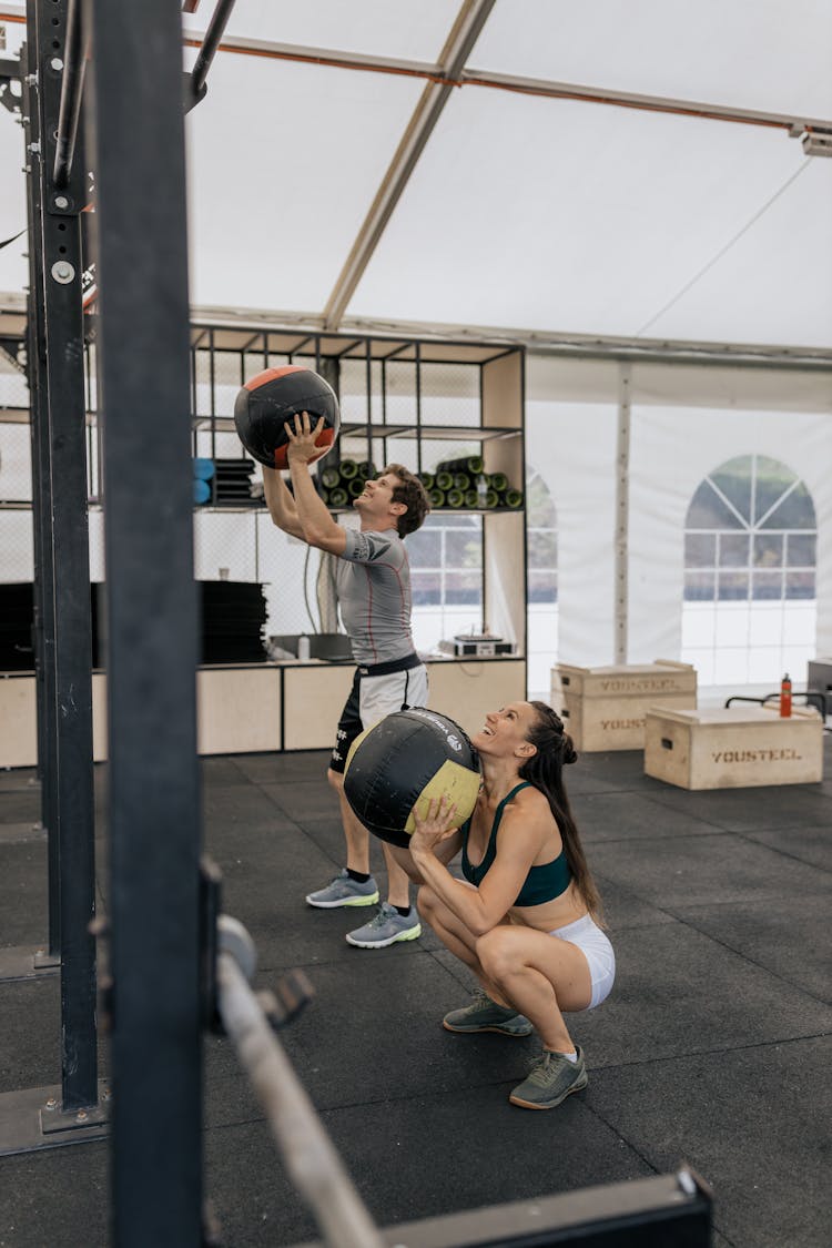 Man And Woman Working Out At The Gym