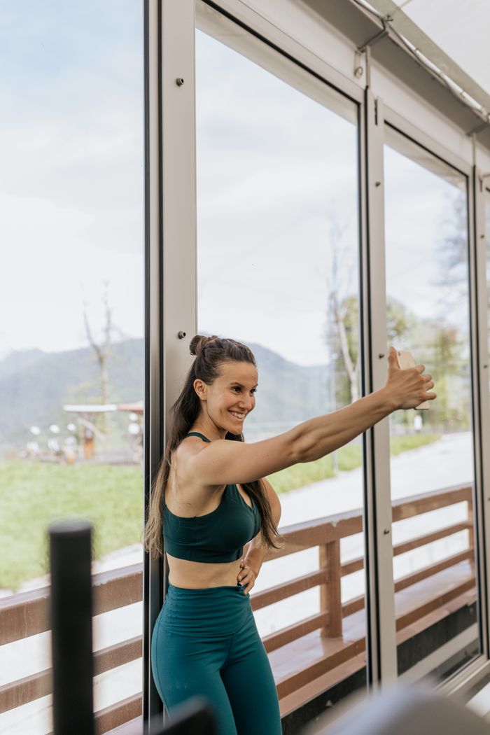 Woman in black activewear resting at the gym