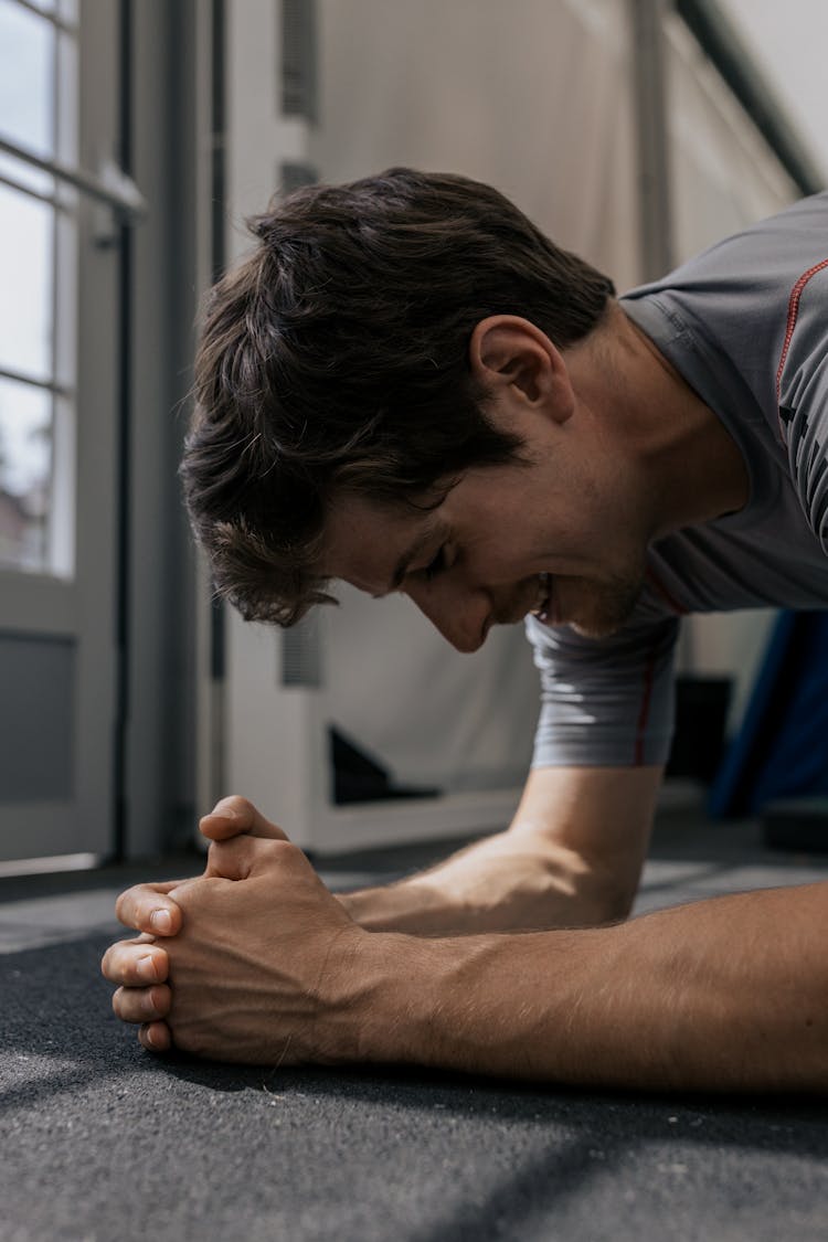 Close-up Shot Of A Man In Gray Shirt Planking