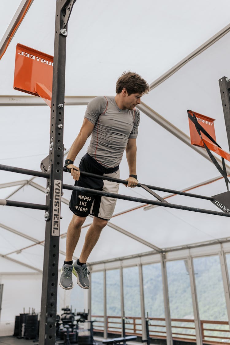 Man In Gray Shirt Working Out At The Gym