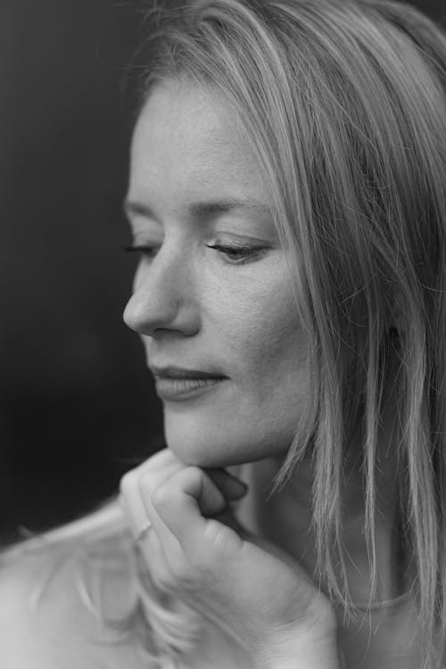 Close Photo of a Woman with Her Hand on Her Chin