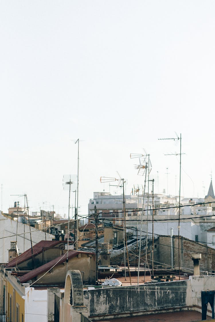 Electric Lines And Antennas Under White Sky