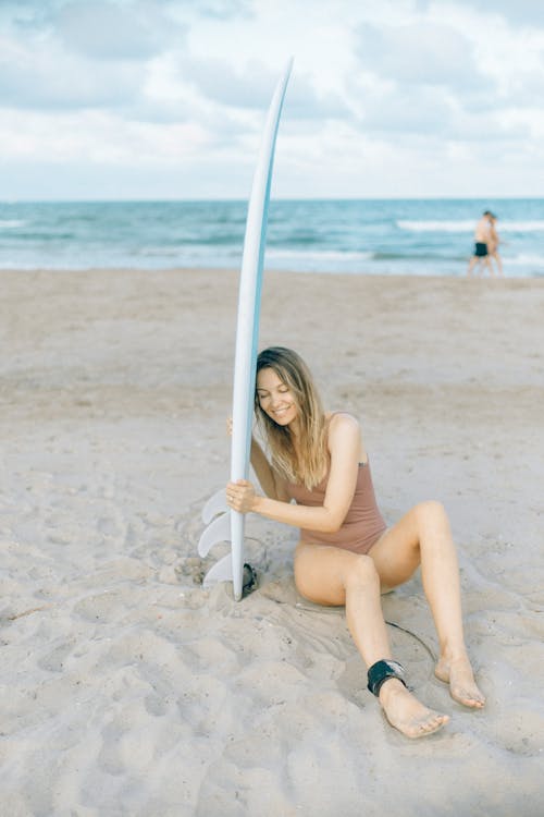 Woman Wearing Swimwear Sitting on Sand