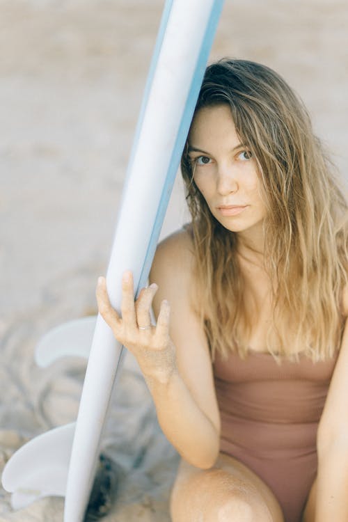 Surfboard Beside a Woman