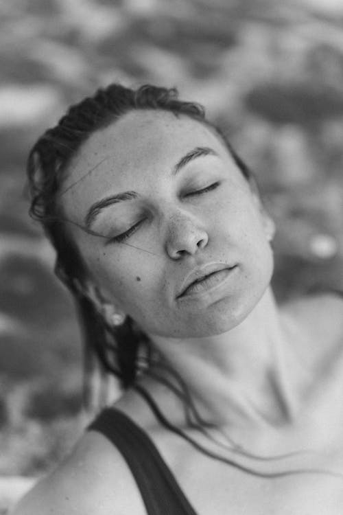 Grayscale Photo of a Woman with Her Eyes Closed