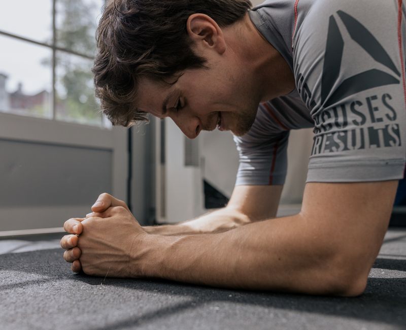 Athlete applying stability patch on arm in a gym setting
