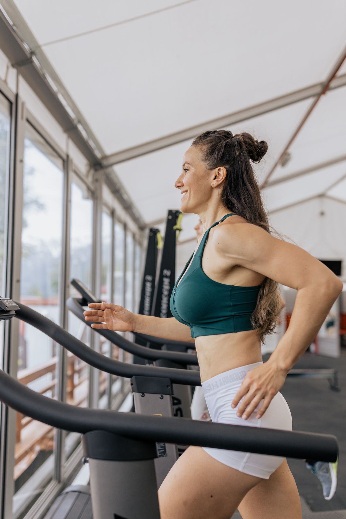Woman exercising on a treadmill in a modern gym