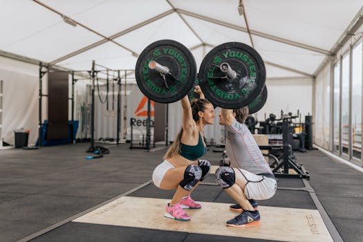 A couple lifting weights together in a gym, promoting fitness and teamwork.