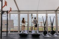 Woman in White Tank Top Sitting on Exercise Equipment